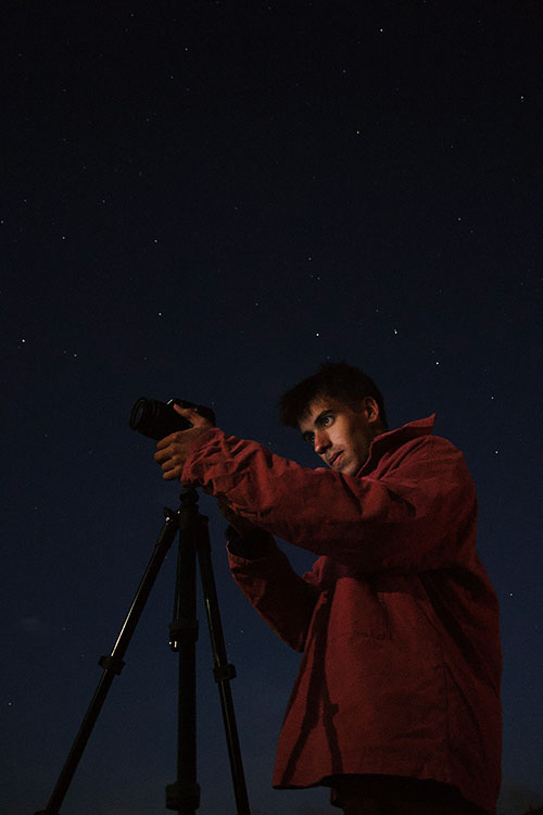 astrophotographer making camera adjustments