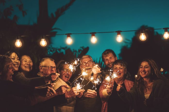 family celebrating with sparklers at night