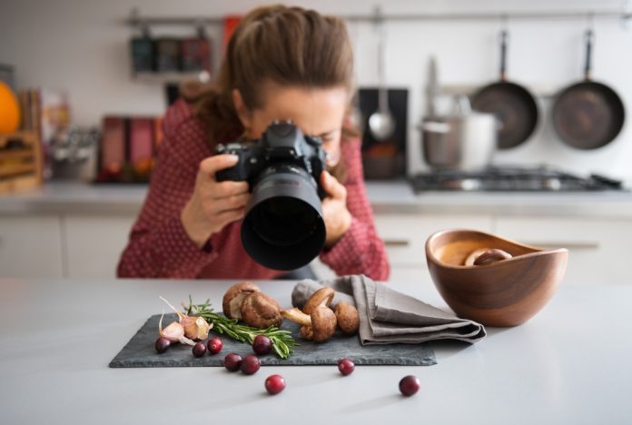 food photographer in a kitchen with fall fruits and vegetables