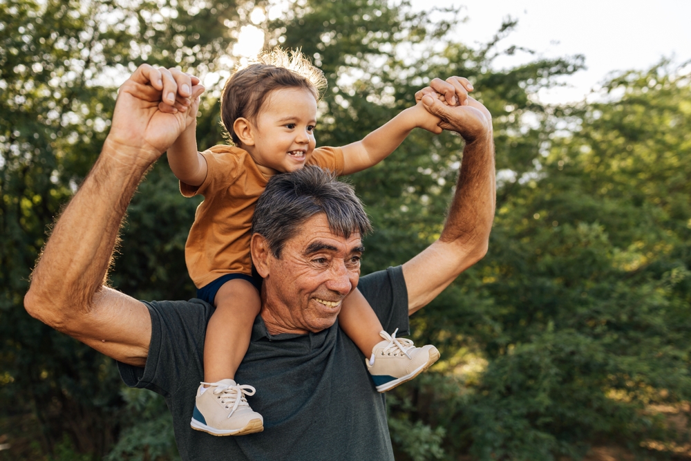 grandfather with his grandson on his shoulders