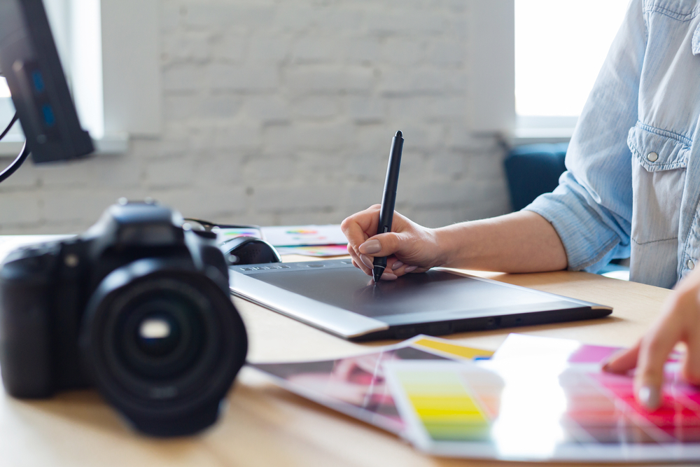 hands retouching images using graphic drawing tablet