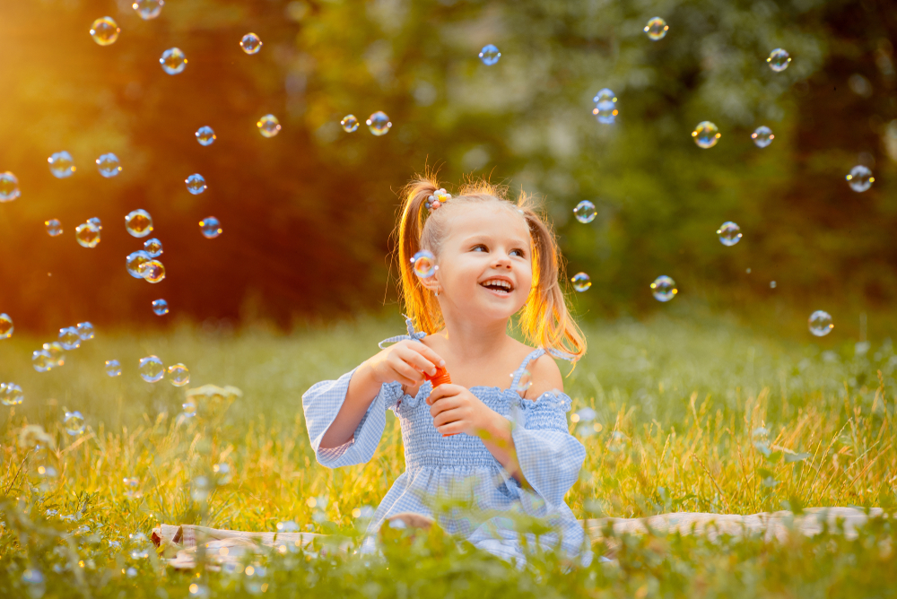 little girl blowing bubbles