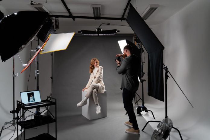 male photographer with female model in photography studio