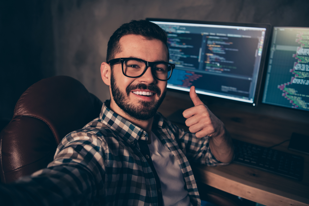 Man updating code, giving thumbs up