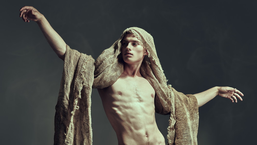 Naked man draped in burlap