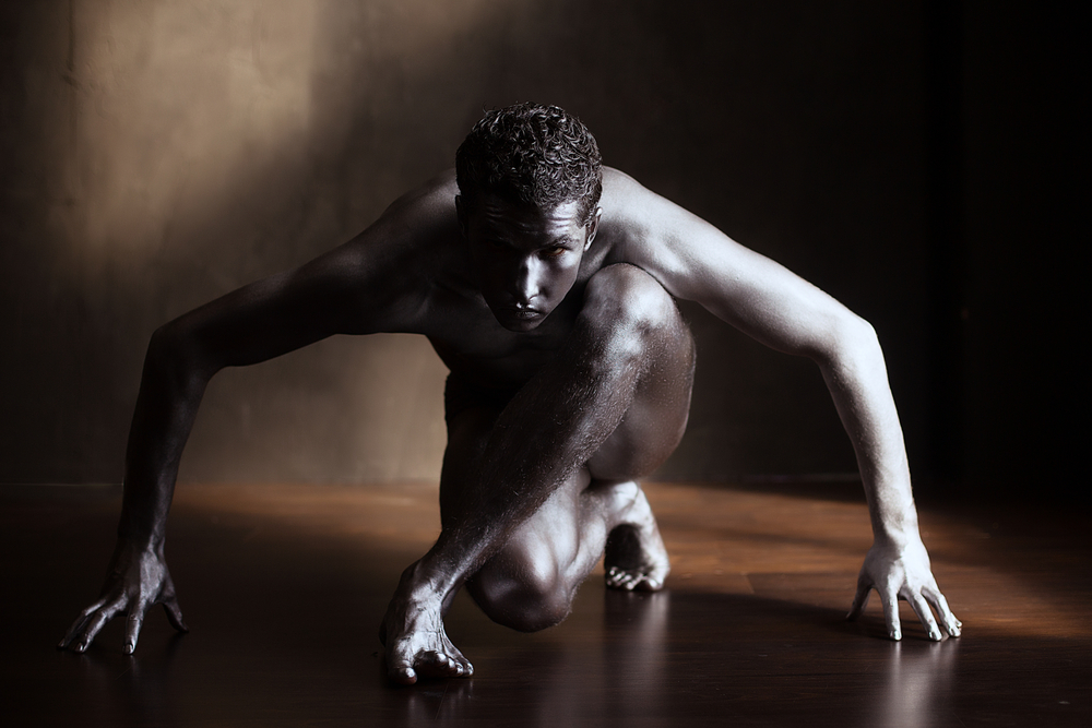 Nude man painted silver