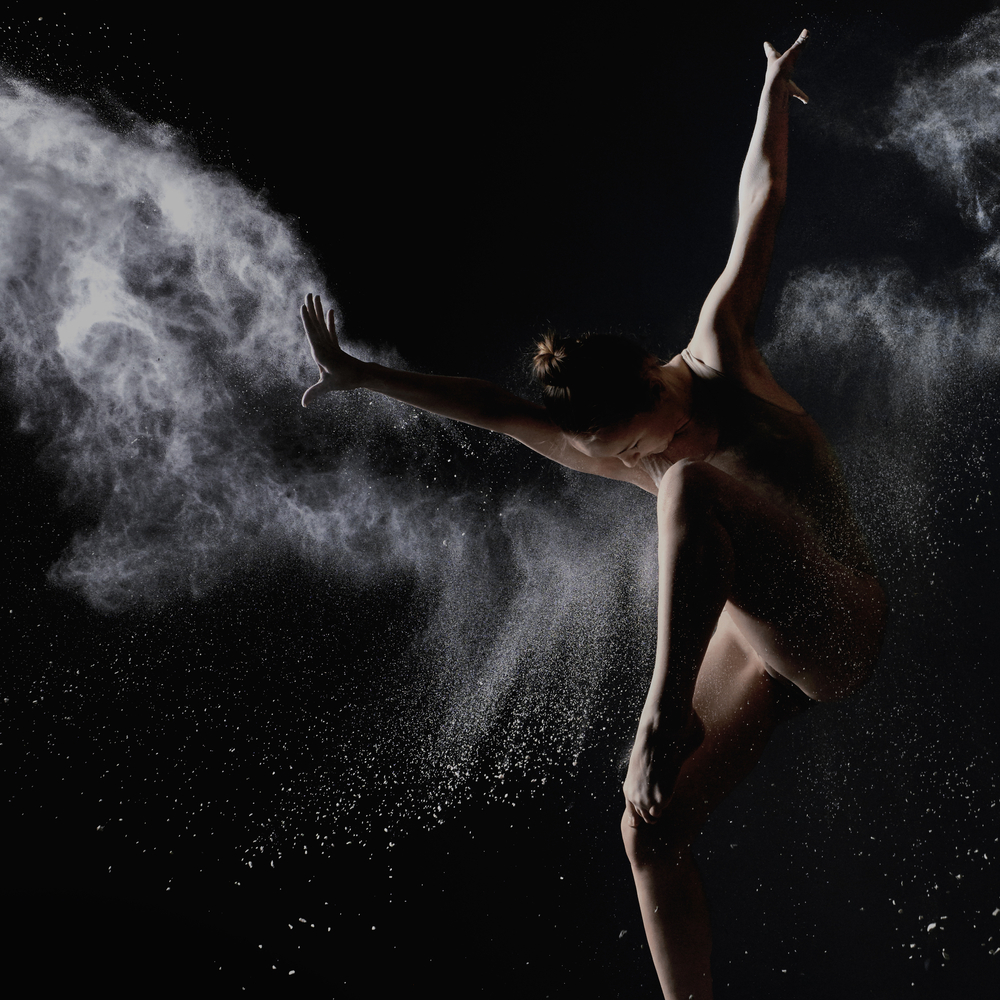 nude woman dancing in white dust cloud