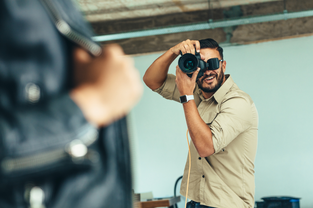 Photographer doing a photo shoot in a studio