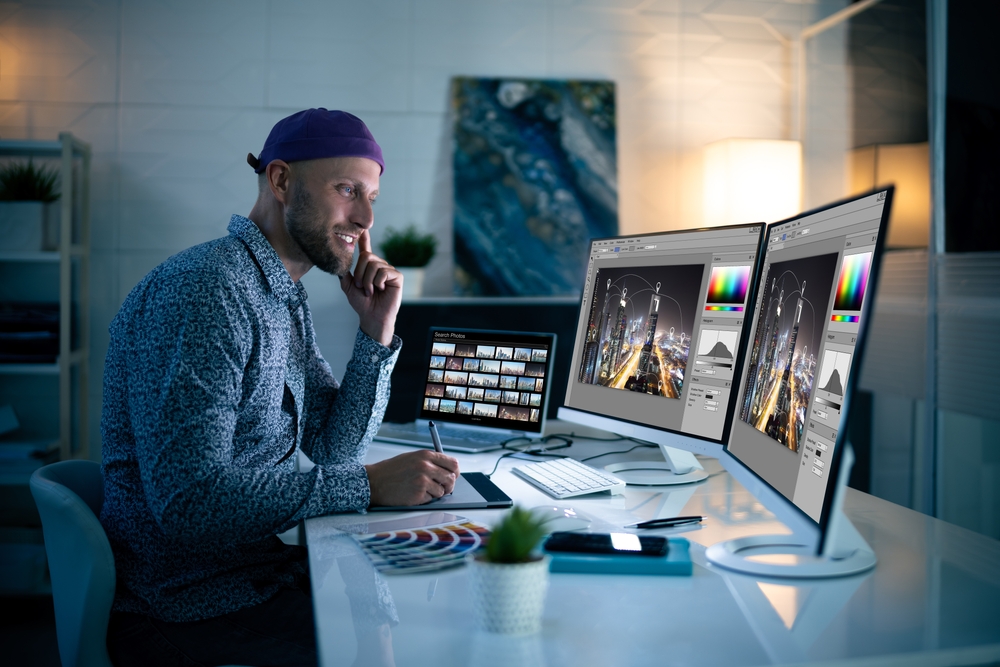 Photographer editing images on a desktop computer