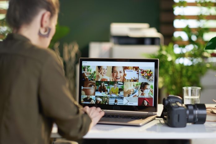 Photographer editing photos on a laptop