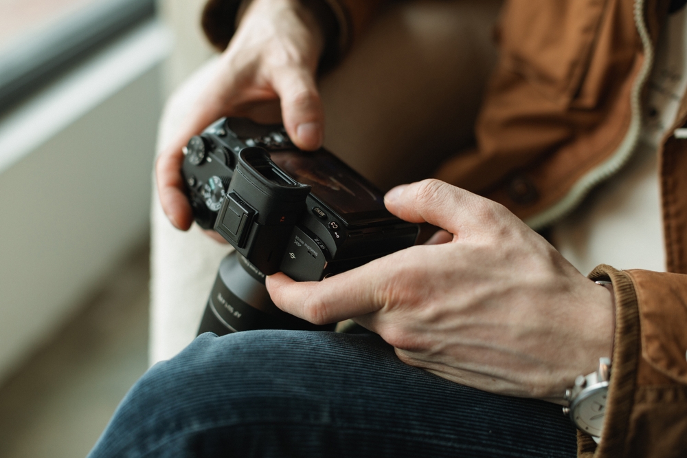 photographer looking at back of camera