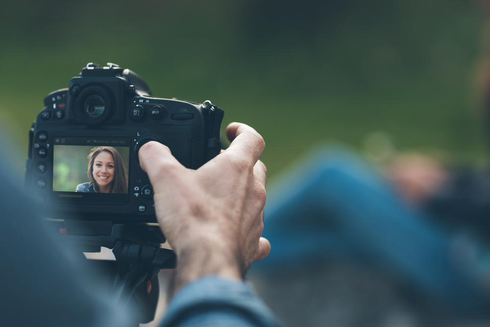 photographer taking a portrait on the camera screen