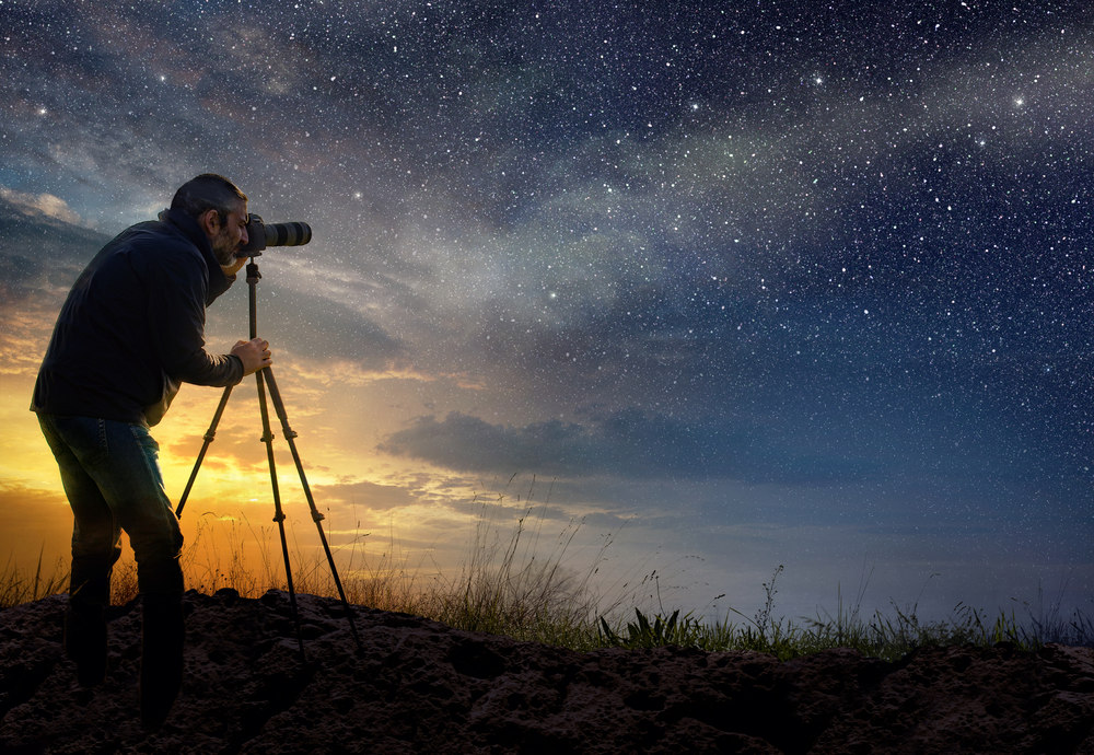 photographer taking photos of night sky