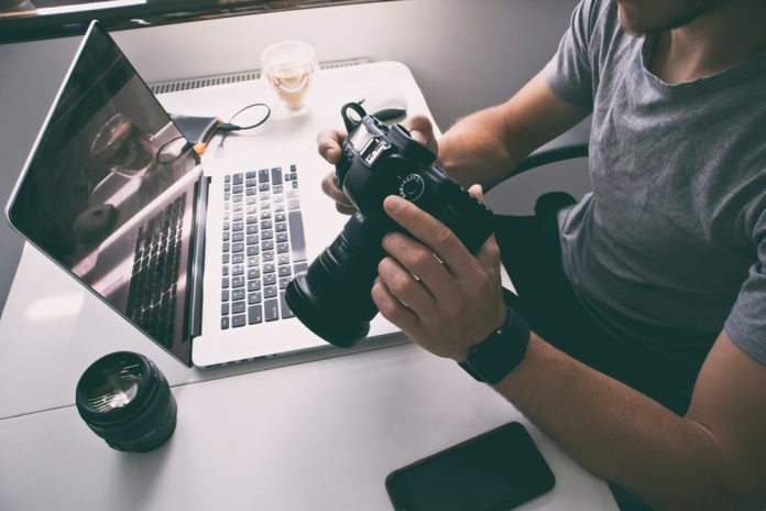 photographer with camera and computer