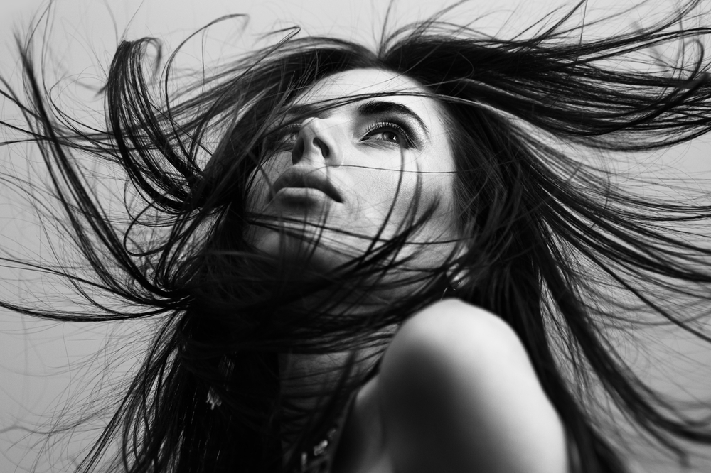 portrait of a woman with flying hair BW