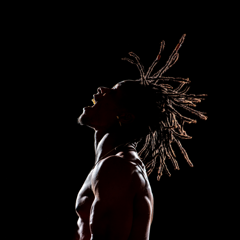 silhouette and rim lighting of a man with dreadlocks