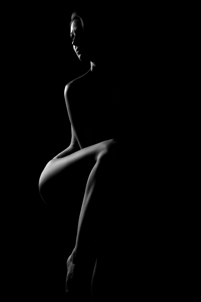 silhouette of a nude woman using body a a compositional element
