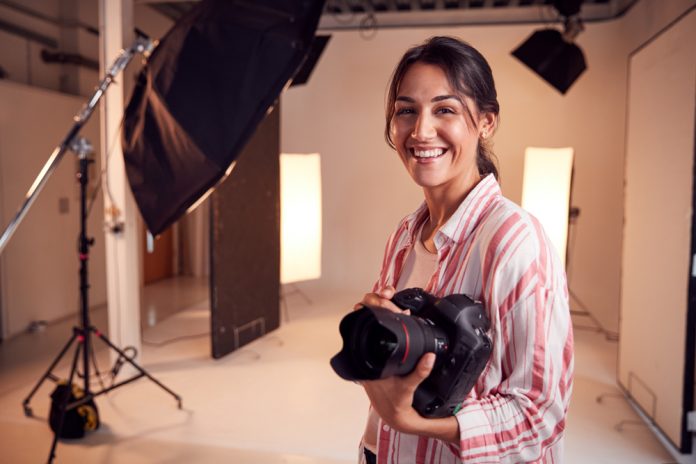 Smiling photographer in her studio