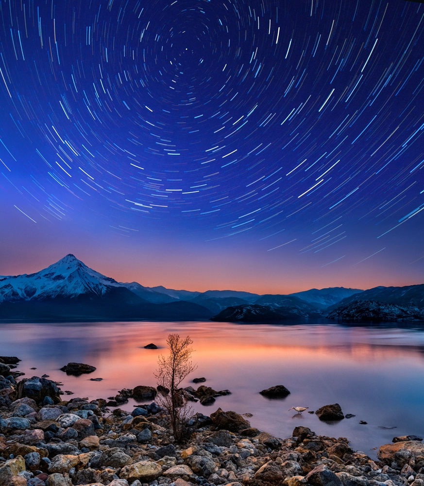 Star trails above a lake in Torres del Paine National Park in Patagonia