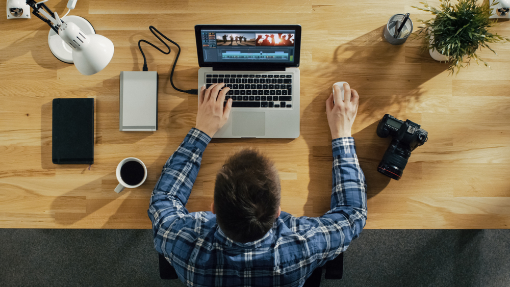 Top View of a Photographer Processing photographs on His Laptop