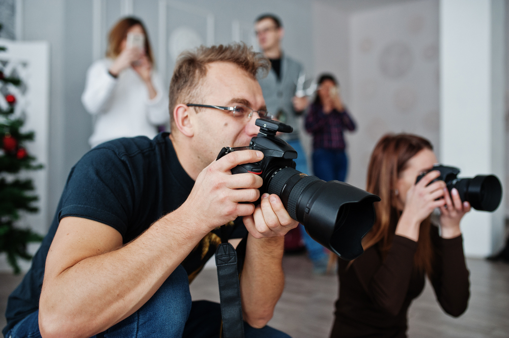 two photographers shooting in a studio