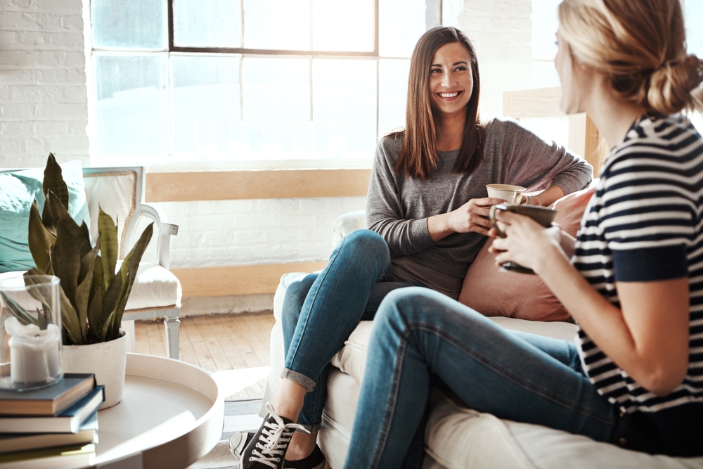 Two Women enjoying coffee in a living room