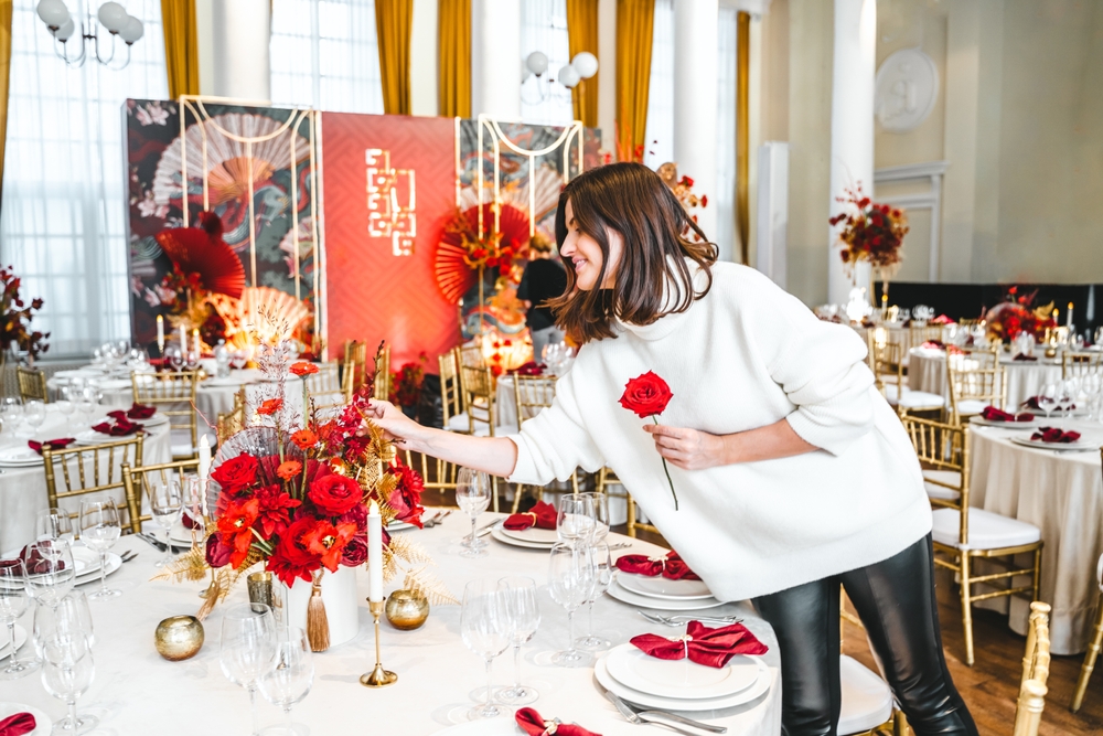 Woman decorating table with flowers